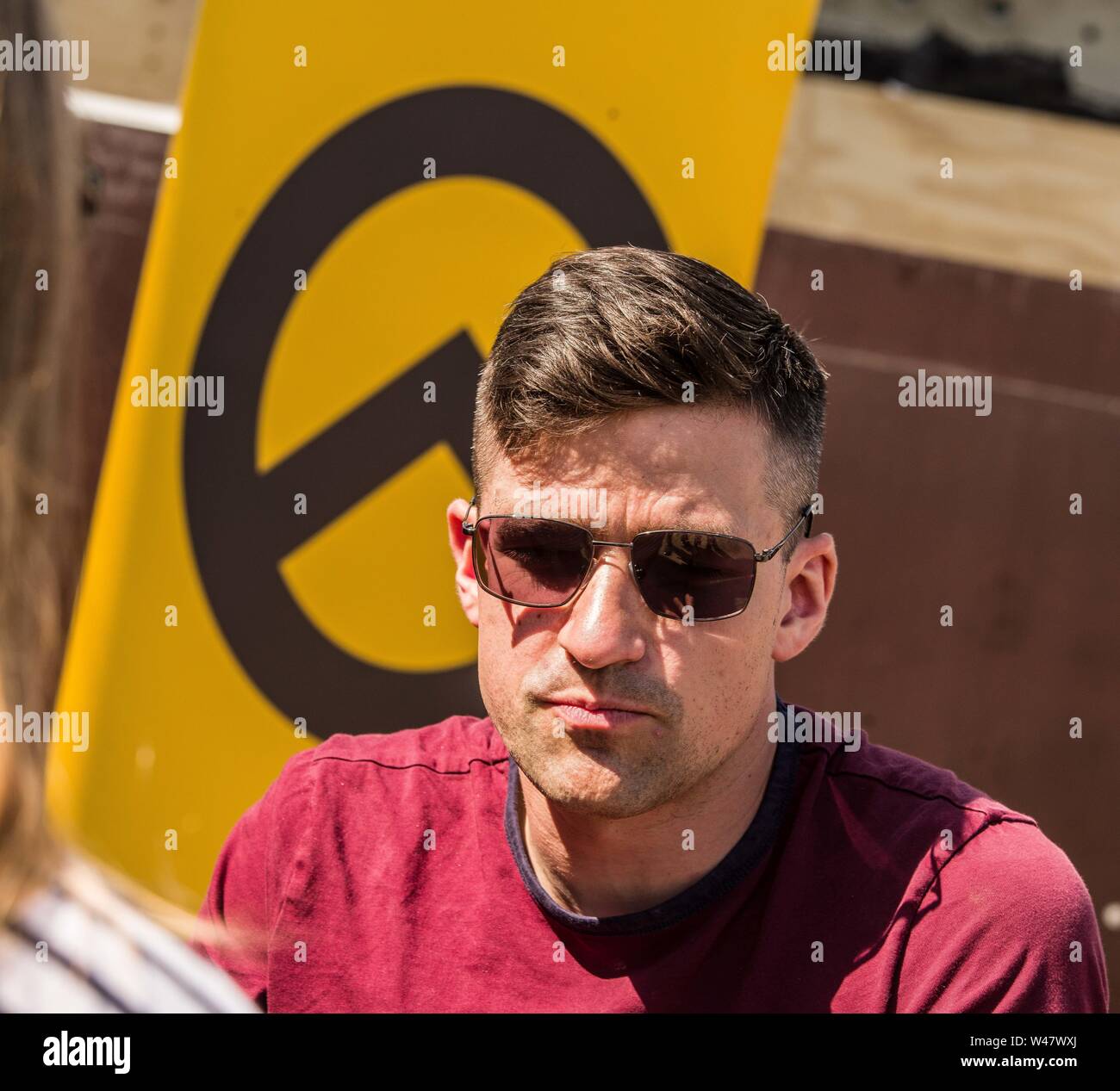 Halle Saale, Sachsen Anhalt, Germany. 20th July, 2019. MARTIN SELLNER, head of the Identitaere Bewegung (Identitaeren Movement). Sellner is a prominent figure of the alt right and international white supremacist movements. He is currently banned from traveling to the United States and has a permanent ban from entering the United Kingdom. Amid protests, the white supremacist, right extremist Identitaere Bewegung (Generation Identity, Identitaren Movement) held a rally in Halle (Saale). The Identitaere have recently faced numerous challenges, including raids to explore the connection of its h Stock Photo