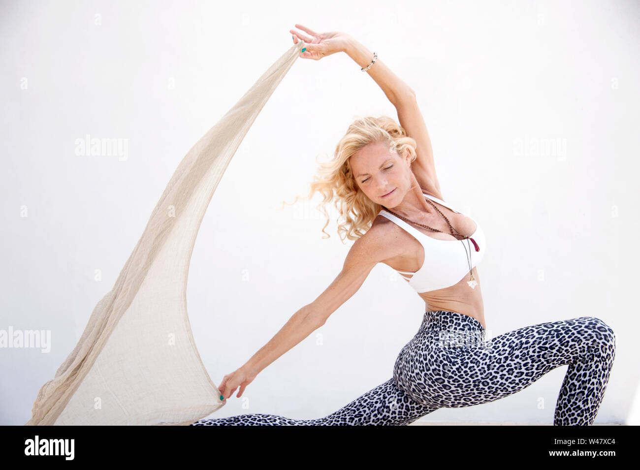 Beautiful mature yoga woman with scarf. Stock Photo