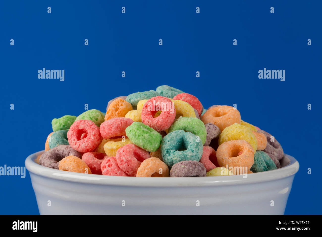 Colorful Fruity Cereal on a Blue Background Stock Photo - Alamy