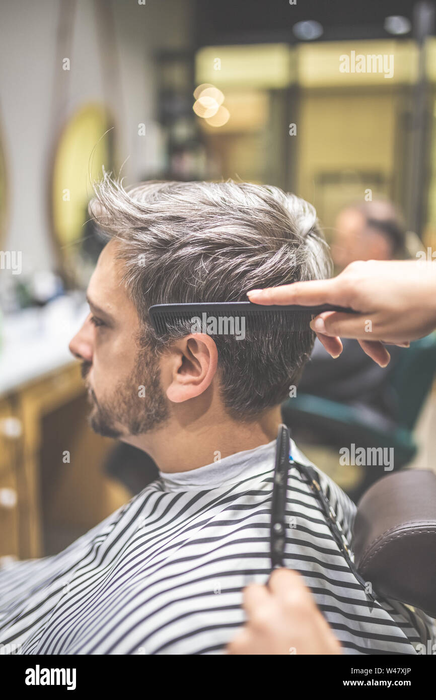 Men hairstyling and haircut in a barber shop or hair salon Stock Photo - Alamy Men hairstyling and haircut in a barber shop or hair salon Stock Photo - Alamy
