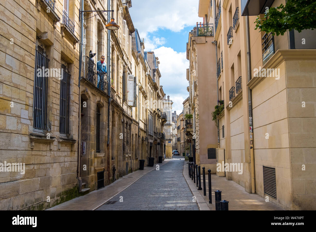Bordeaux, France - May 5, 2019: Mannequin of a black cat and a man on the balcony of an residential building in historical center of Bordeaux, France Stock Photo