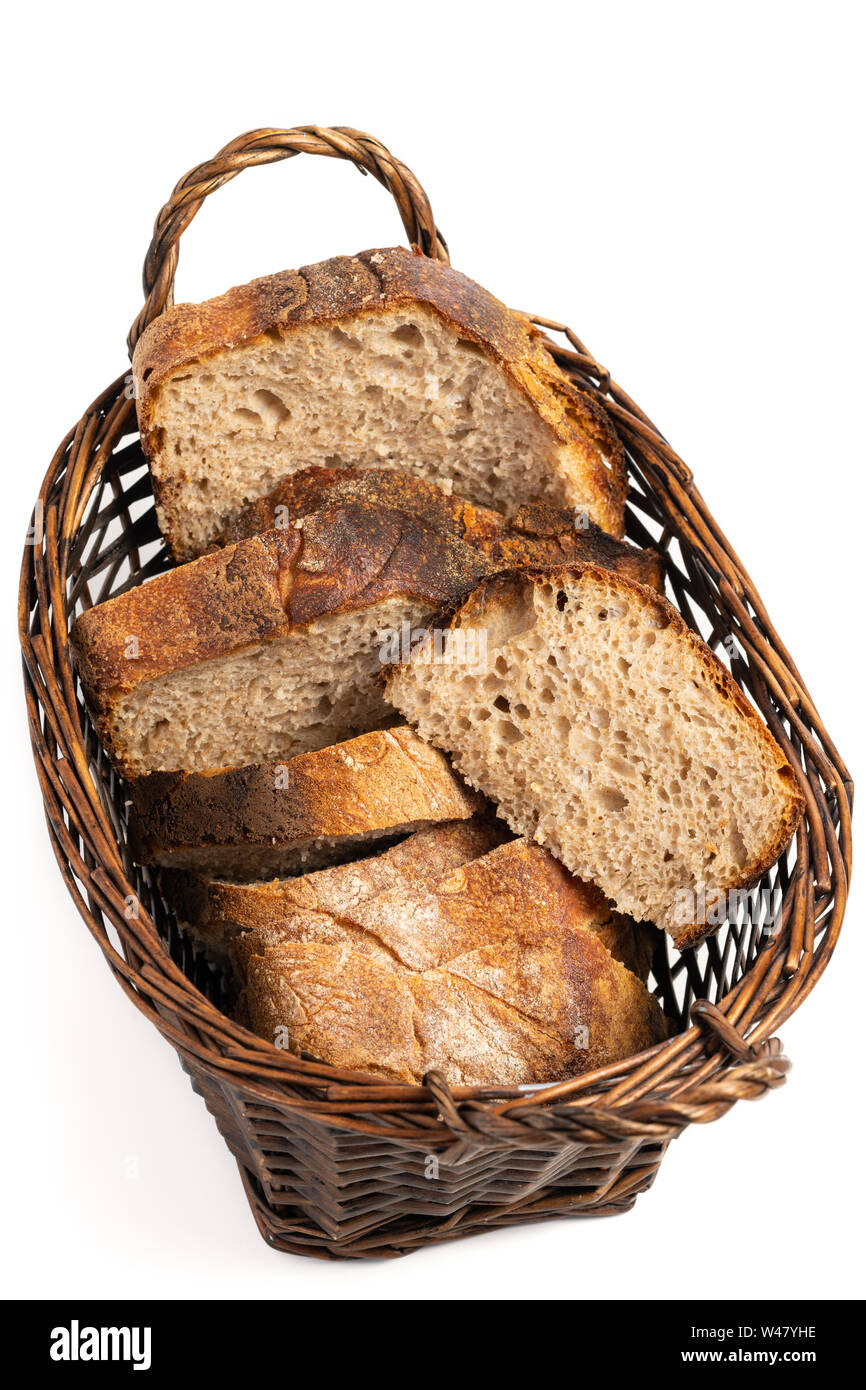Close up of hearty artisan sourdough bread slices in a bread basket. Stock Photo