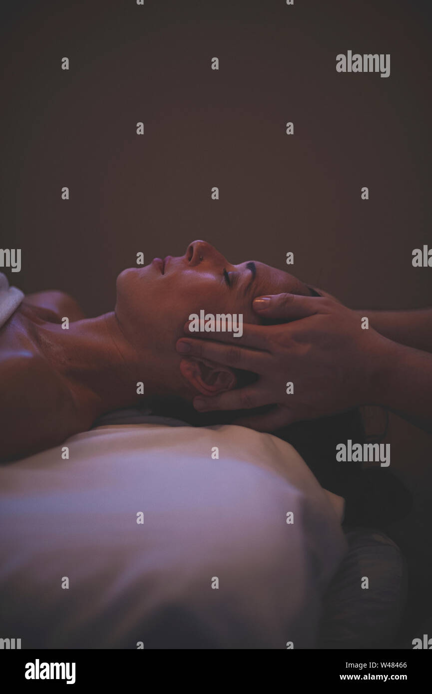 Male therapist giving woman client massage therapy bodywork. he is