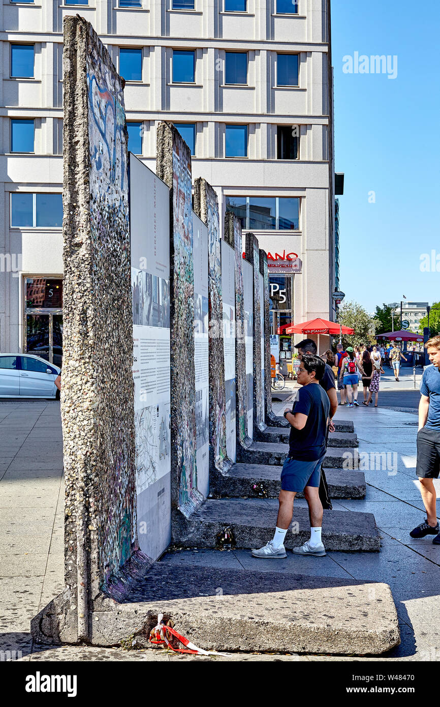 The Berlin Wall was a guarded concrete barrier that physically and ideologically divided Berlin 