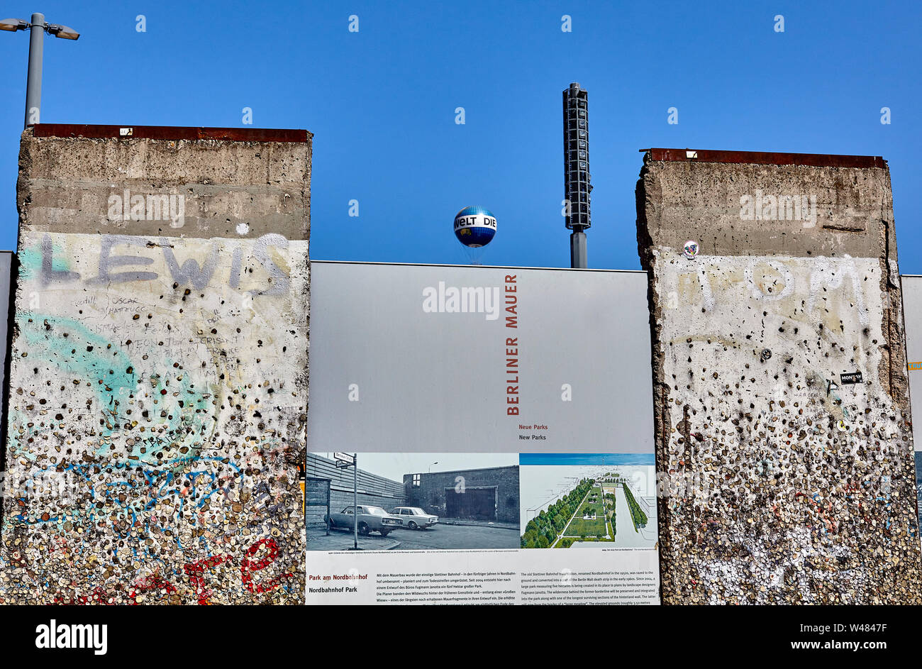 The Berlin Wall was a guarded concrete barrier that physically and ideologically divided Berlin 