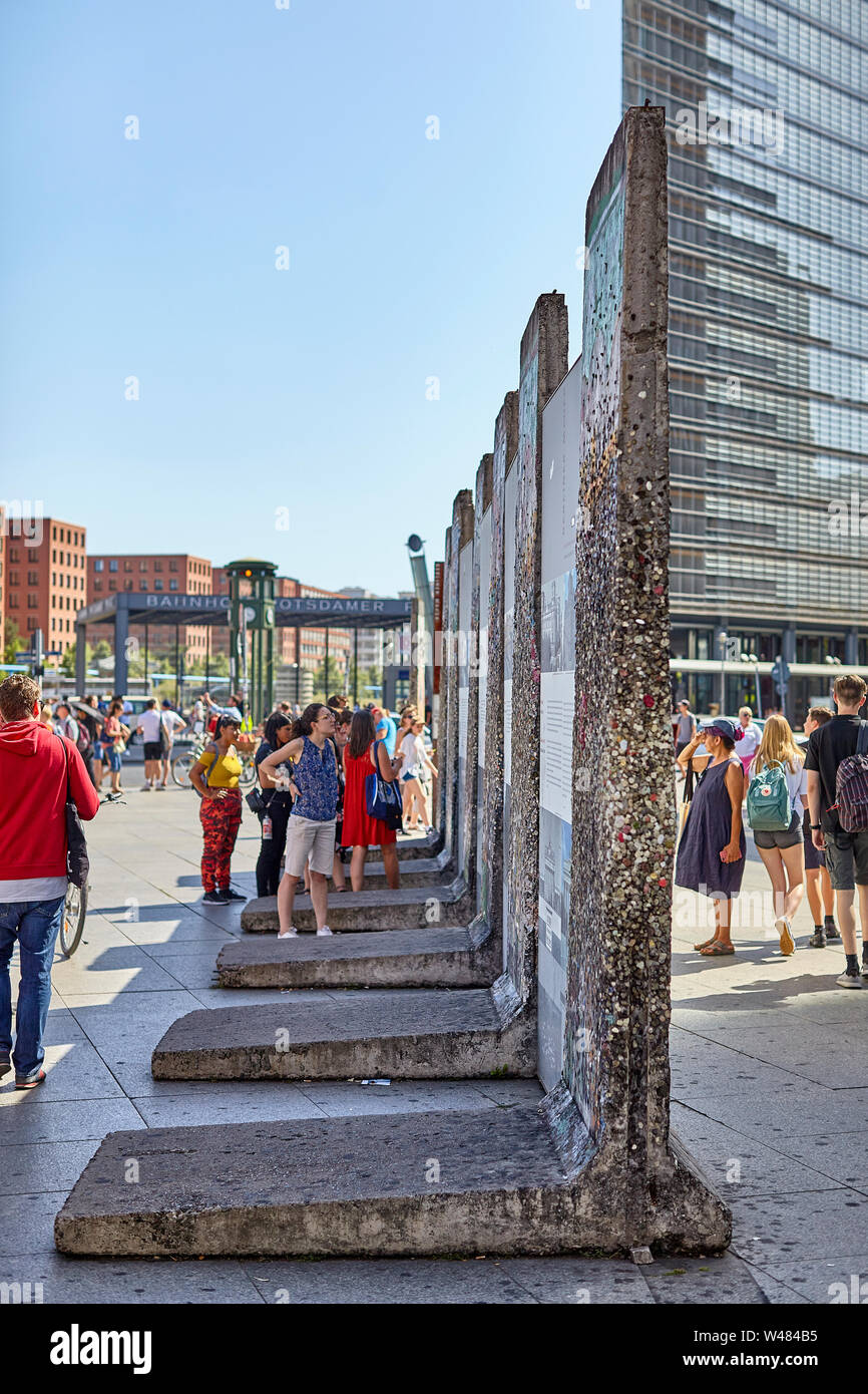 The Berlin Wall was a guarded concrete barrier that physically and ideologically divided Berlin 