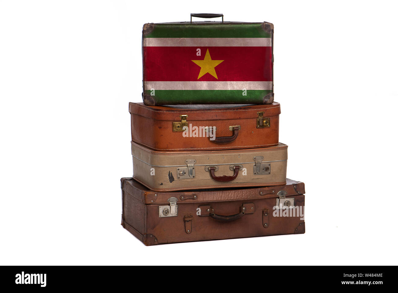 Suriname, Surinamese travel concept. Group of vintage suitcases isolated on white background Stock Photo