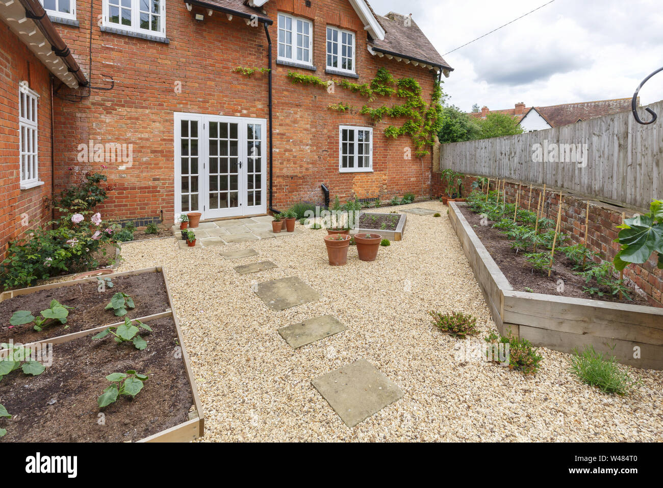 House and garden with a terrace patio and french doors, gravel hard