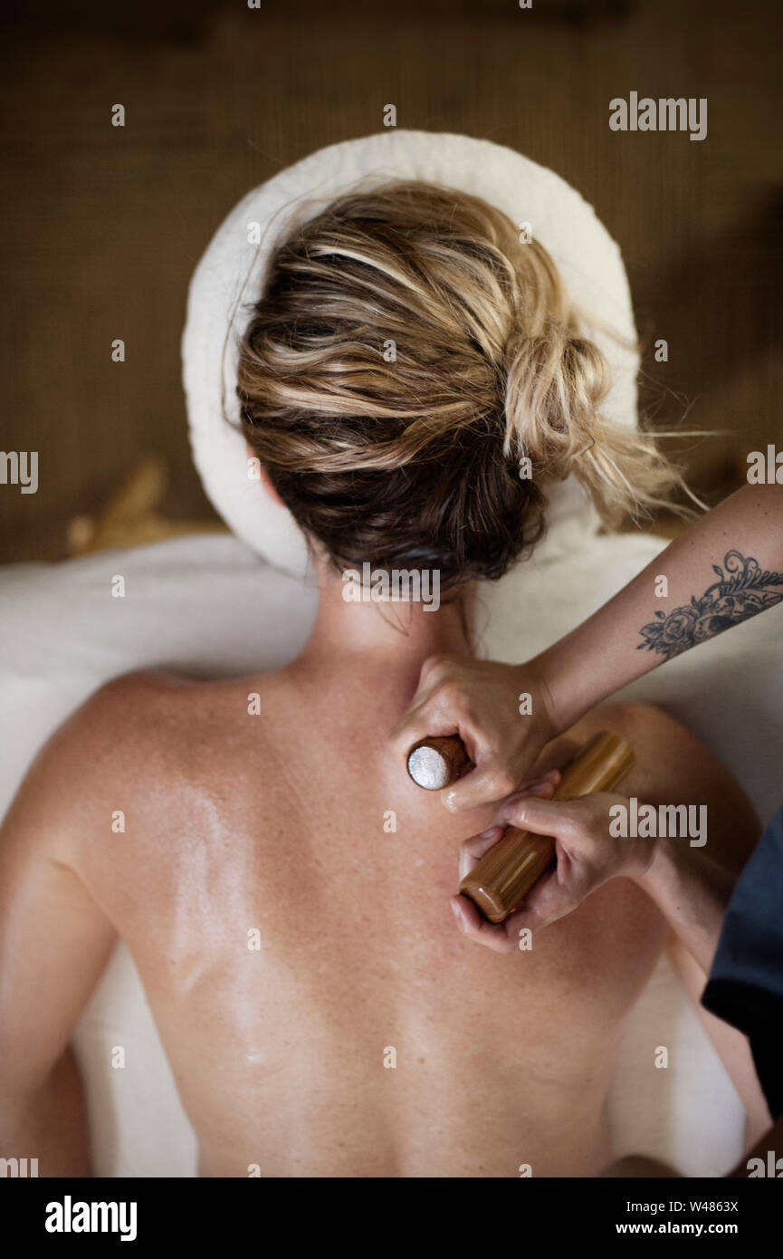 Hot Bamboo Massage Referred To As Bamboo Fusion Massage Is A Type Of Massage Therapy The Smooth Sticks Are More Penetrating For Deep Tissue Stock Photo Alamy