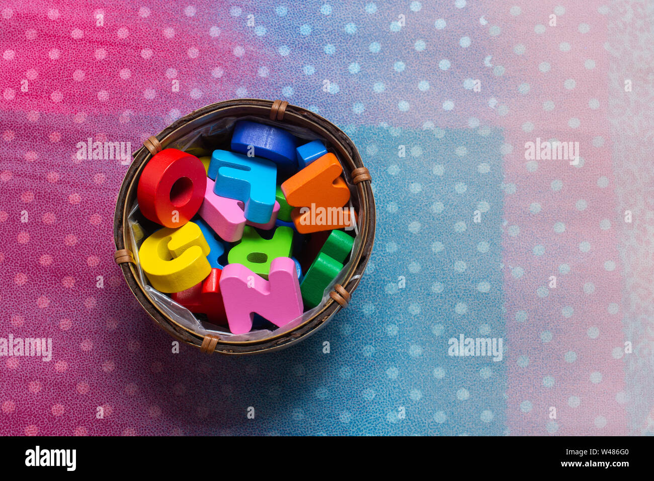 Colorful wooden letters in a container on a colorful background Stock ...