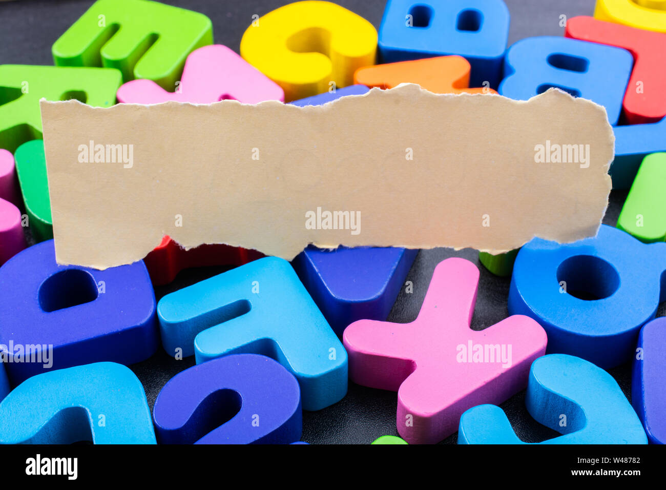 Torn paper placed on Colorful Letters of Alphabet Stock Photo - Alamy