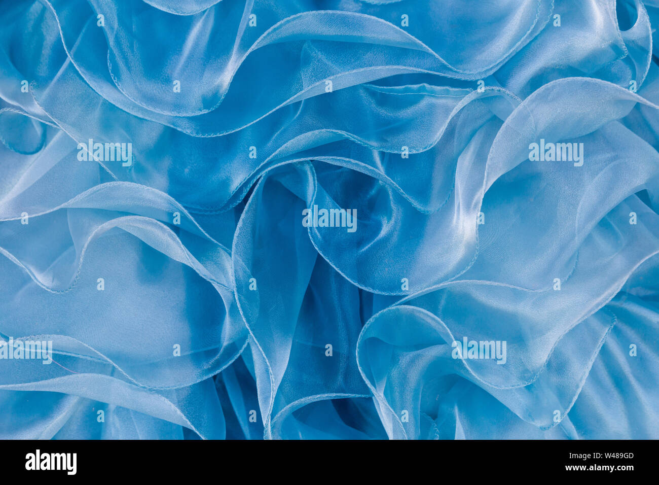 Close up abstraction of bluegreen Quinceanera dress in a shop window