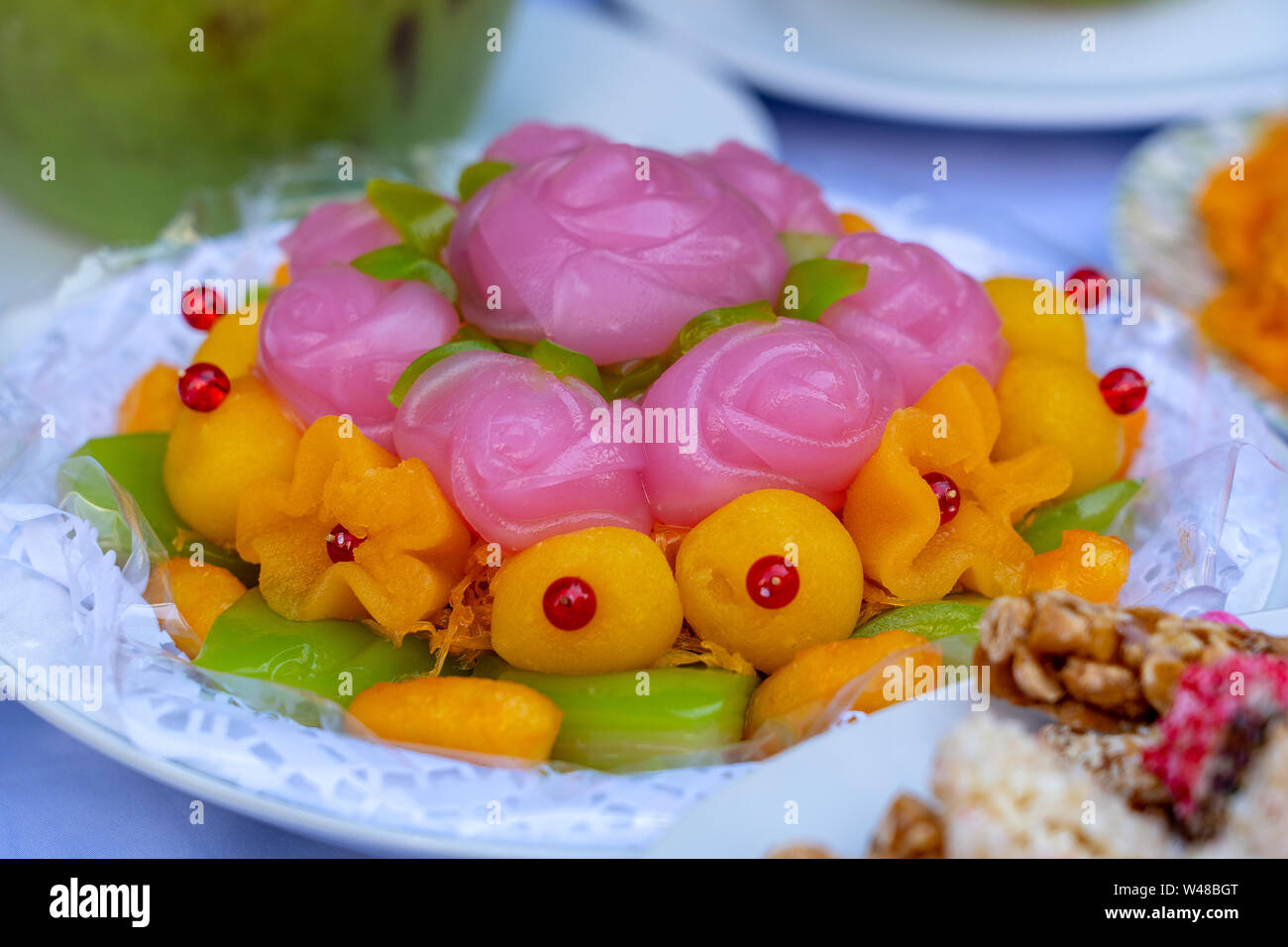 Thai sweet cake. Thai traditional dessert in pink rose flowers shaped. One of nine famous Thai auspicious desserts in Thailand. Rose shape from Khanom Stock Photo