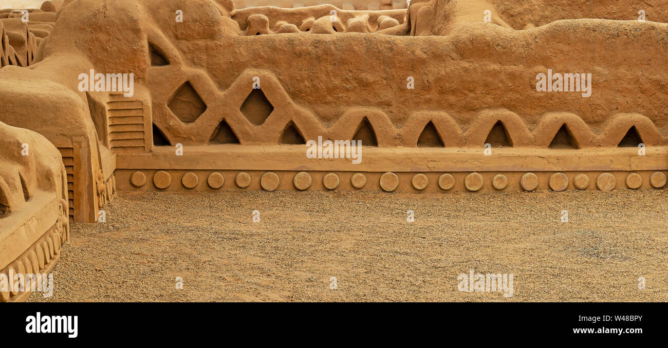 Panorama of the adobe walls and decorations in the archaeological site of Chan Chan made by the Chimu civilization near Trujillo, Peru. Stock Photo