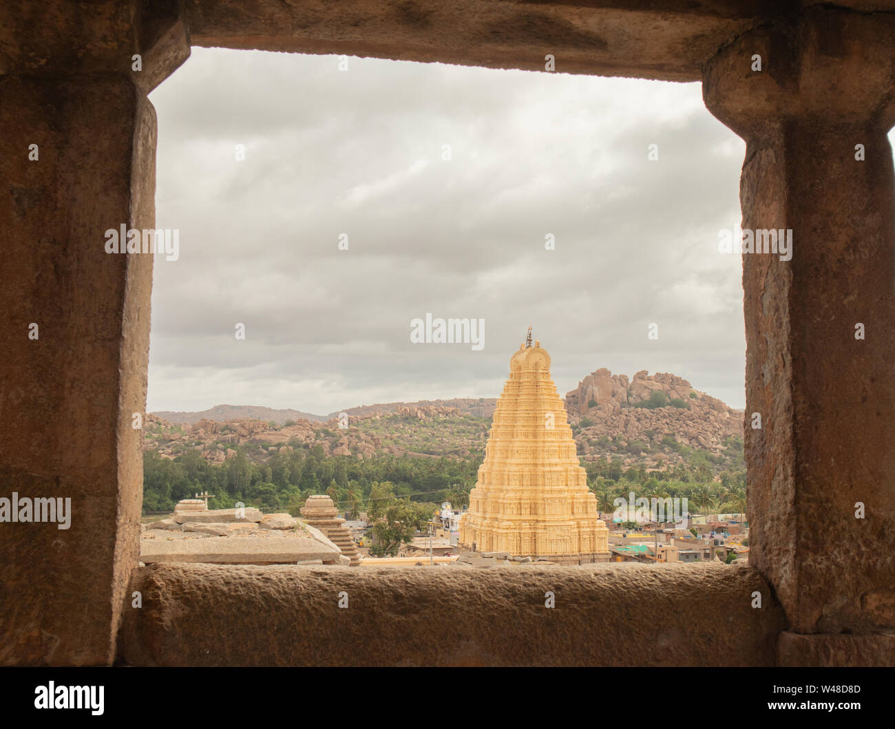 Virupaksha hindu temple gopuram through the Mandapa and ruins, Hampi, India. Stock Photo