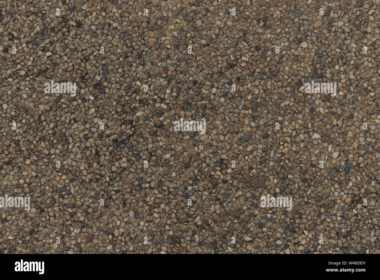 Pebble floor close up texture, brown sandwash surface Stock Photo