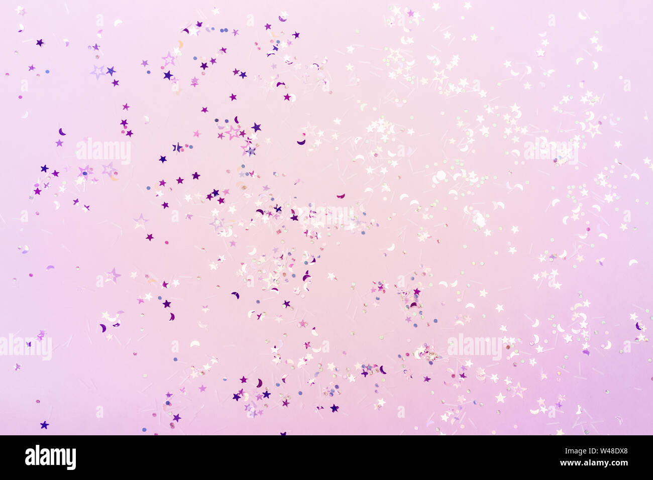 Holographic glitter confetti in pastel neon lights. Festive trendy