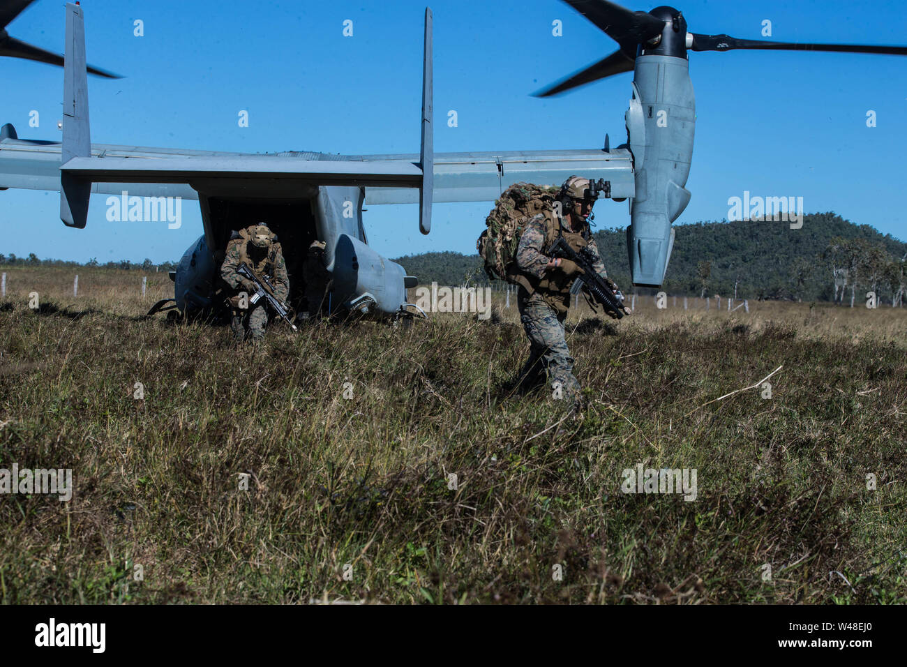Marines with the 31st Marine Expeditionary Unit’s Amphibious Reconnaissance Platoon disembark an MV-22B Osprey tiltrotor aircraft with Marine Medium Tiltrotor Squadron 265 (Reinforced), 31st MEU, during a reconnaissance and surveillance insert into Stanage Bay Training Area, Queensland, Australia, July 19, 2019. The 31st MEU is currently participating in Talisman Saber 2019 off the coast of Northern Australia. A bilateral, biennial event, Talisman Sabre is designed to improve U.S. and Australian combat training, readiness, and interoperability through realistic, relevant training necessary to Stock Photo