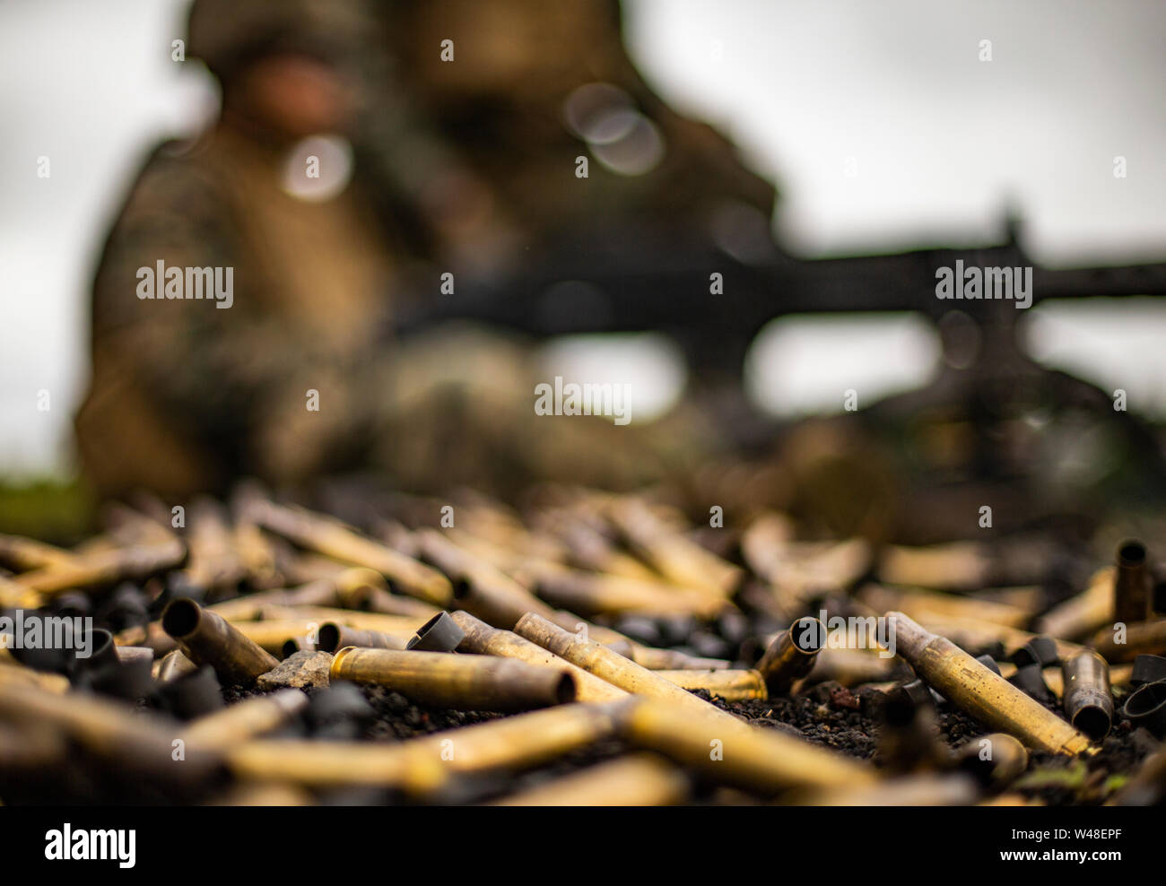 A pile of expended brass and clips lies on the ground around an M2A1 .50-caliber machine gun during exercise Eagle Wrath 19 at Combined Arms Training Center (CATC) Camp Fuji, Japan, July 12, 2019. Eagle Wrath is an annual MWSS-171 exercise at Combined Arms Training Center Camp Fuji, Japan, designed to increase squadron proficiency in a forward operating environment and practice for real-world contingency missions. (U.S. Marine Corps photo by Cpl. Seth Rosenberg) Stock Photo