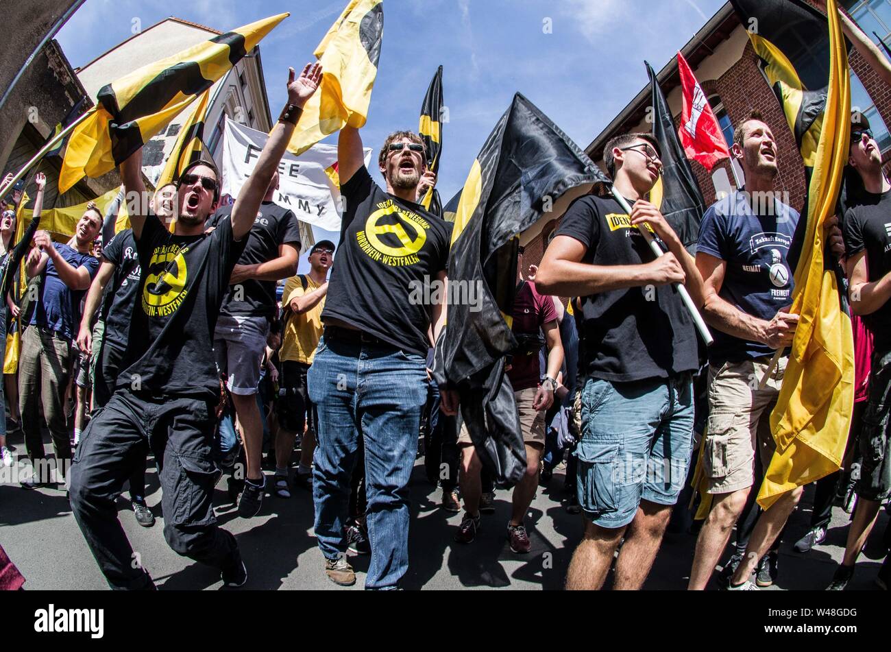 Halle, Germany. 20th July, 2019. Young right-extremists with the white supremacist Identitaere Bewegung (Generation Identity hold flags with the symbol of the group at a rally in Halle an der Saale, Germany. Credit: Sachelle Babbar/ZUMA Wire/Alamy Live News Stock Photo