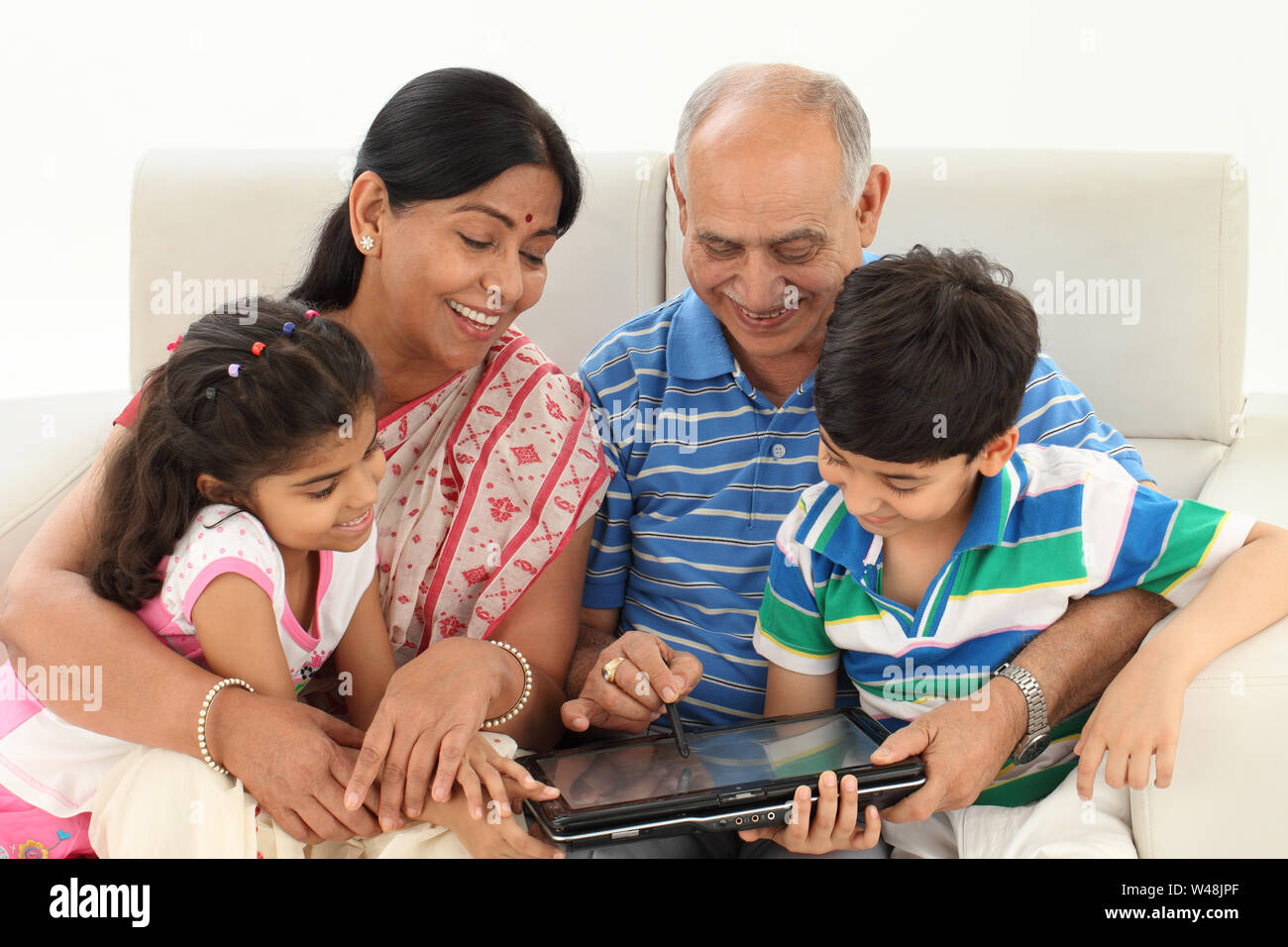 Family using a digital tablet and smiling Stock Photo - Alamy
