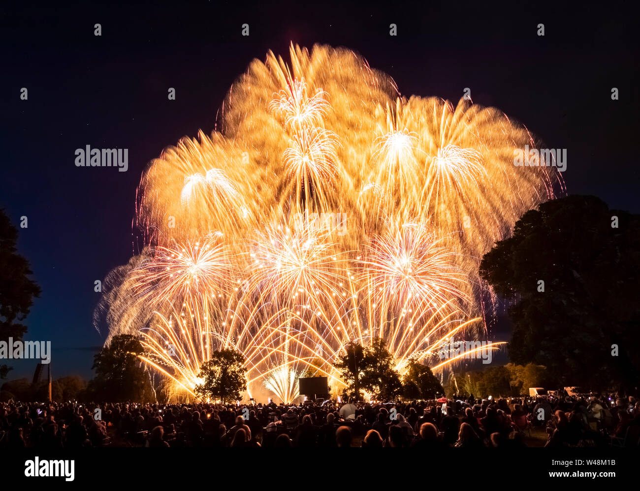 Thousands of people watch a fireworks display, as the UK's finest fireworks companies compete during the Fireworks Champions at Newby Hall in Yorkshire. Stock Photo