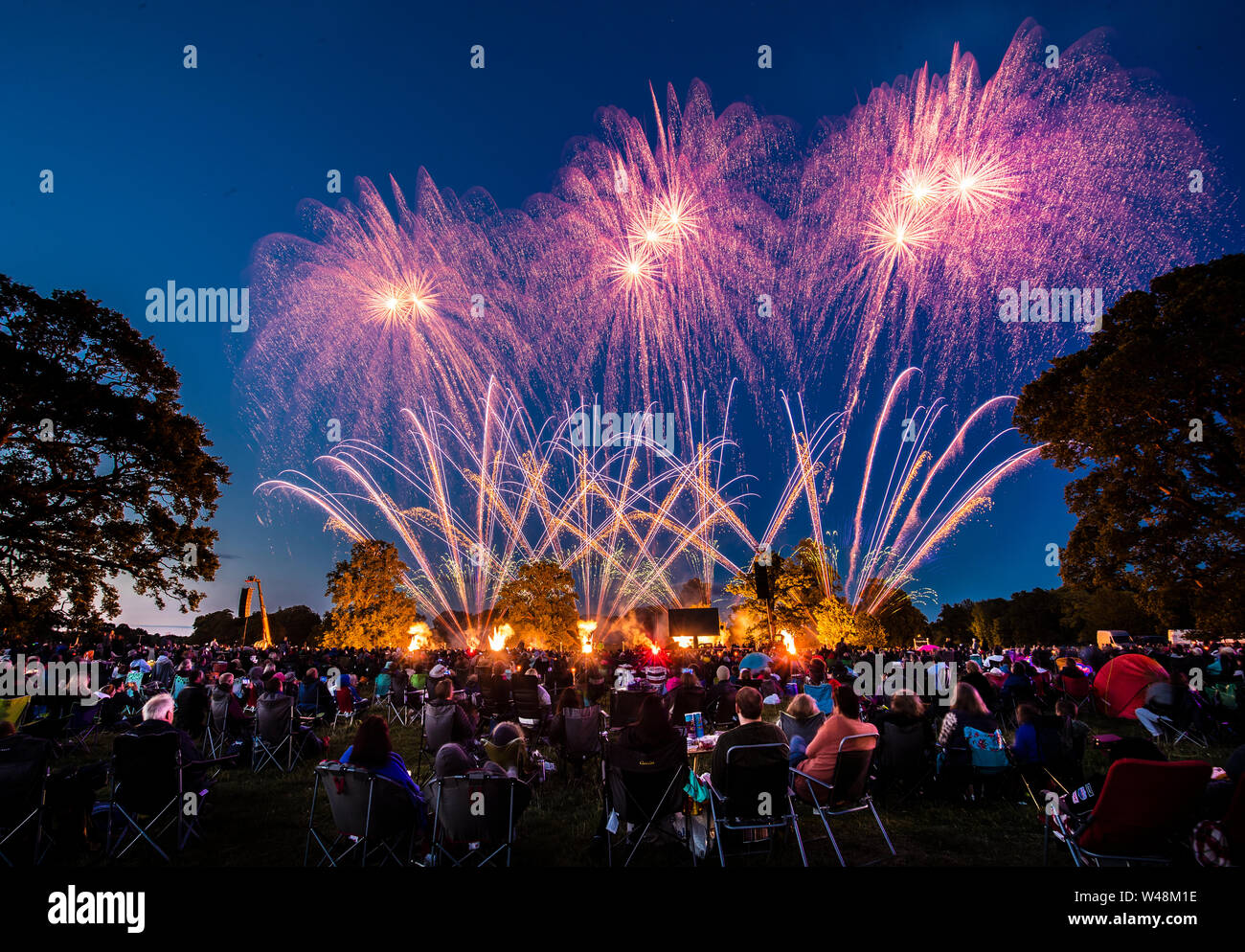Thousands of people watch a fireworks display, as the UK's finest fireworks companies compete during the Fireworks Champions at Newby Hall in Yorkshire. Stock Photo