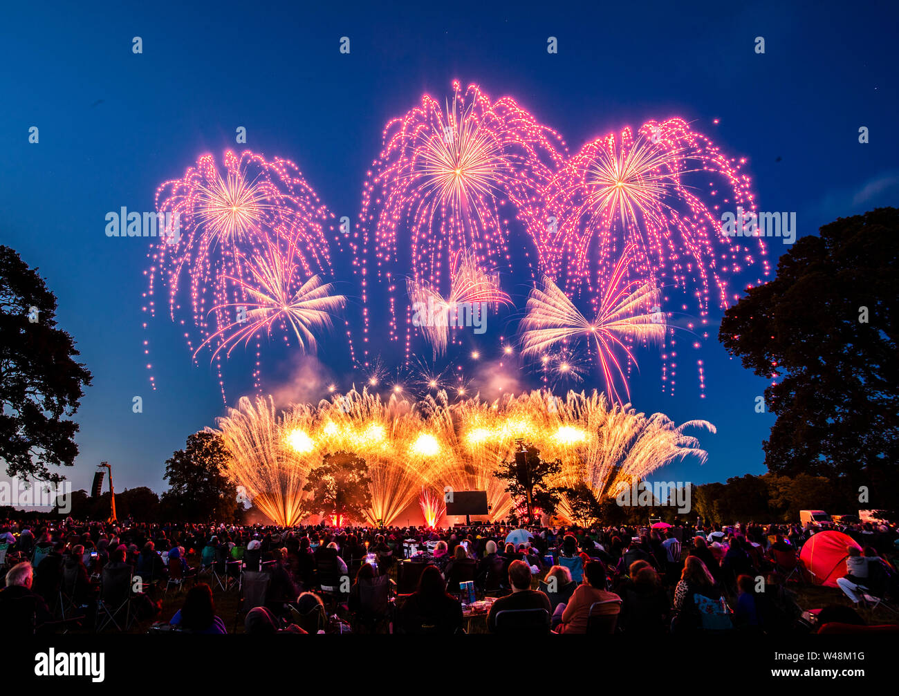 Thousands of people watch a fireworks display, as the UK's finest fireworks companies compete during the Fireworks Champions at Newby Hall in Yorkshire. Stock Photo