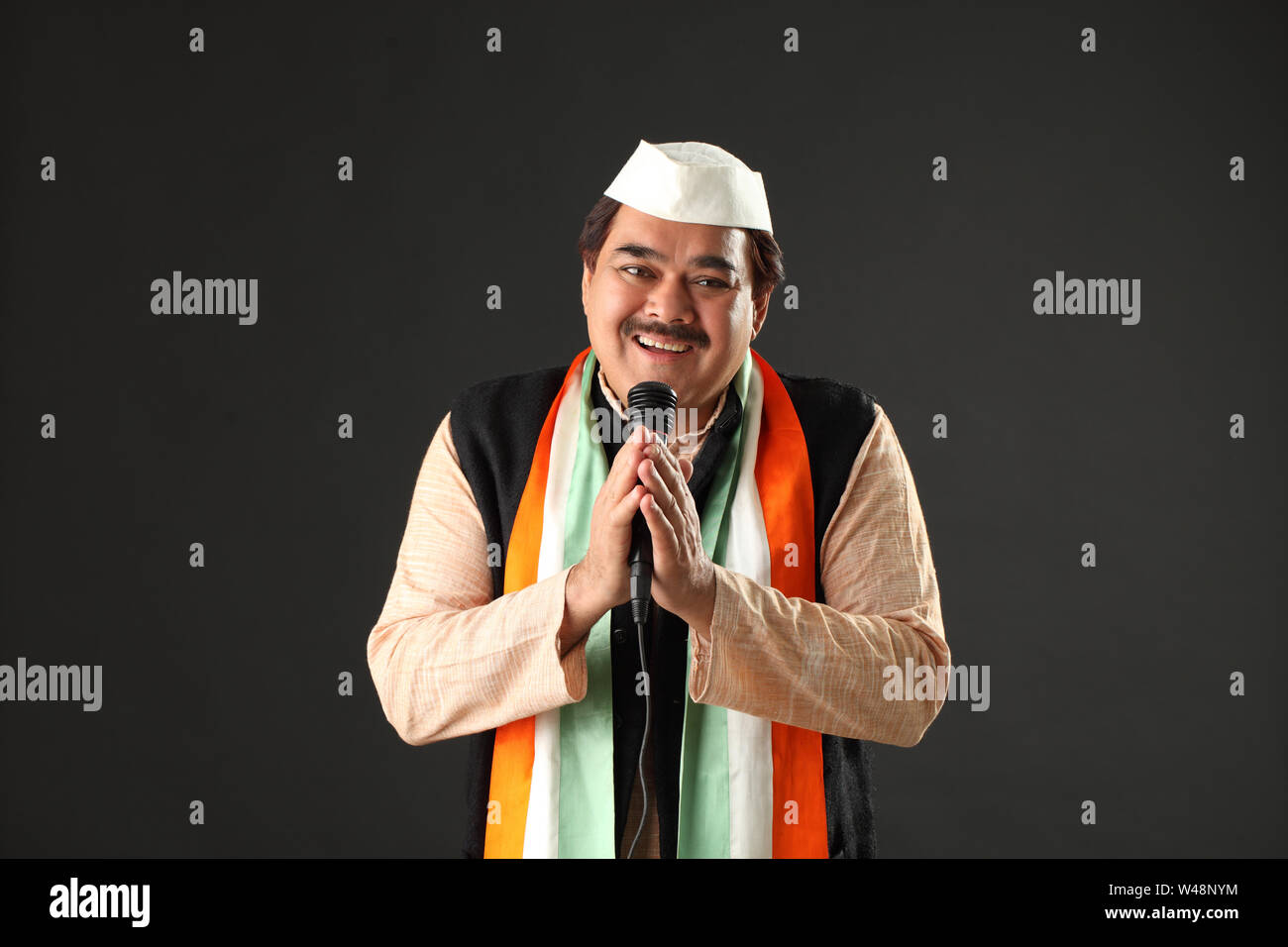 Politician giving speech and welcoming with hands joined Stock Photo