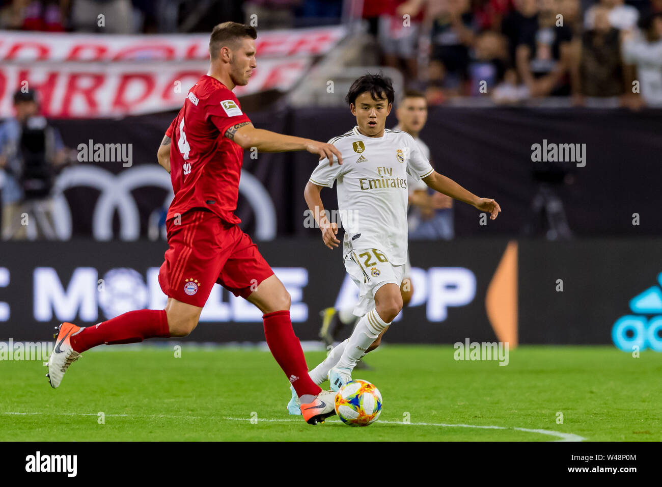 Houston, Texas, USA. 20th July, 2019. Real Madrid forward Takefusa Kubo (26) goes for the ball from Bayern Munich defender Niklas Sule (4) during the International Champions Cup between Real Madrid and Bayern Munich FC at NRG Stadium in Houston, Texas. The final Bayern Munich wins 3-1. © Maria Lysaker/CSM/Alamy Live News Stock Photo
