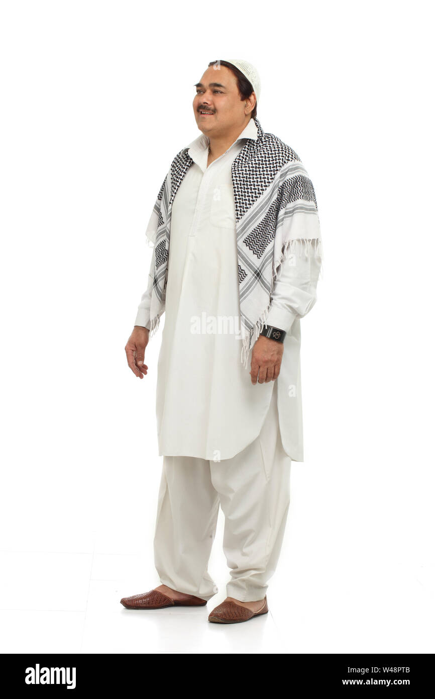 Muslim man standing and smiling Stock Photo