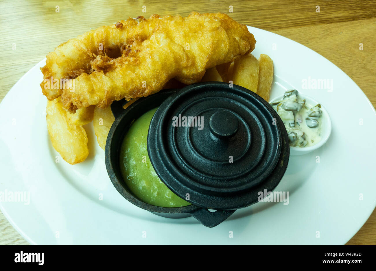 Fish & Chips with a tub of mushy peas Stock Photo
