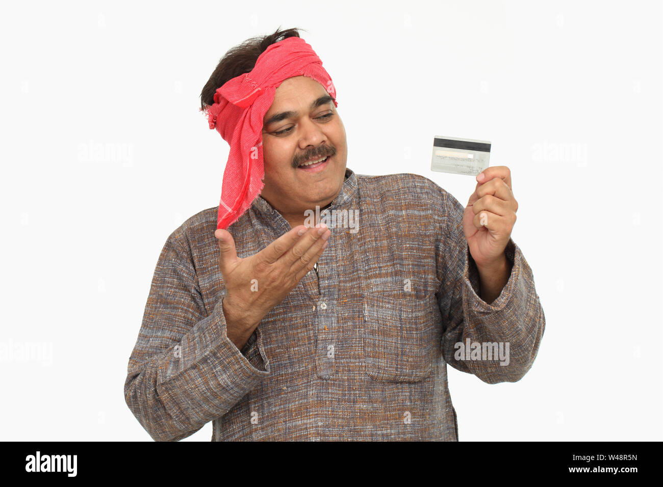 Rural man showing credit card and smiling Stock Photo - Alamy