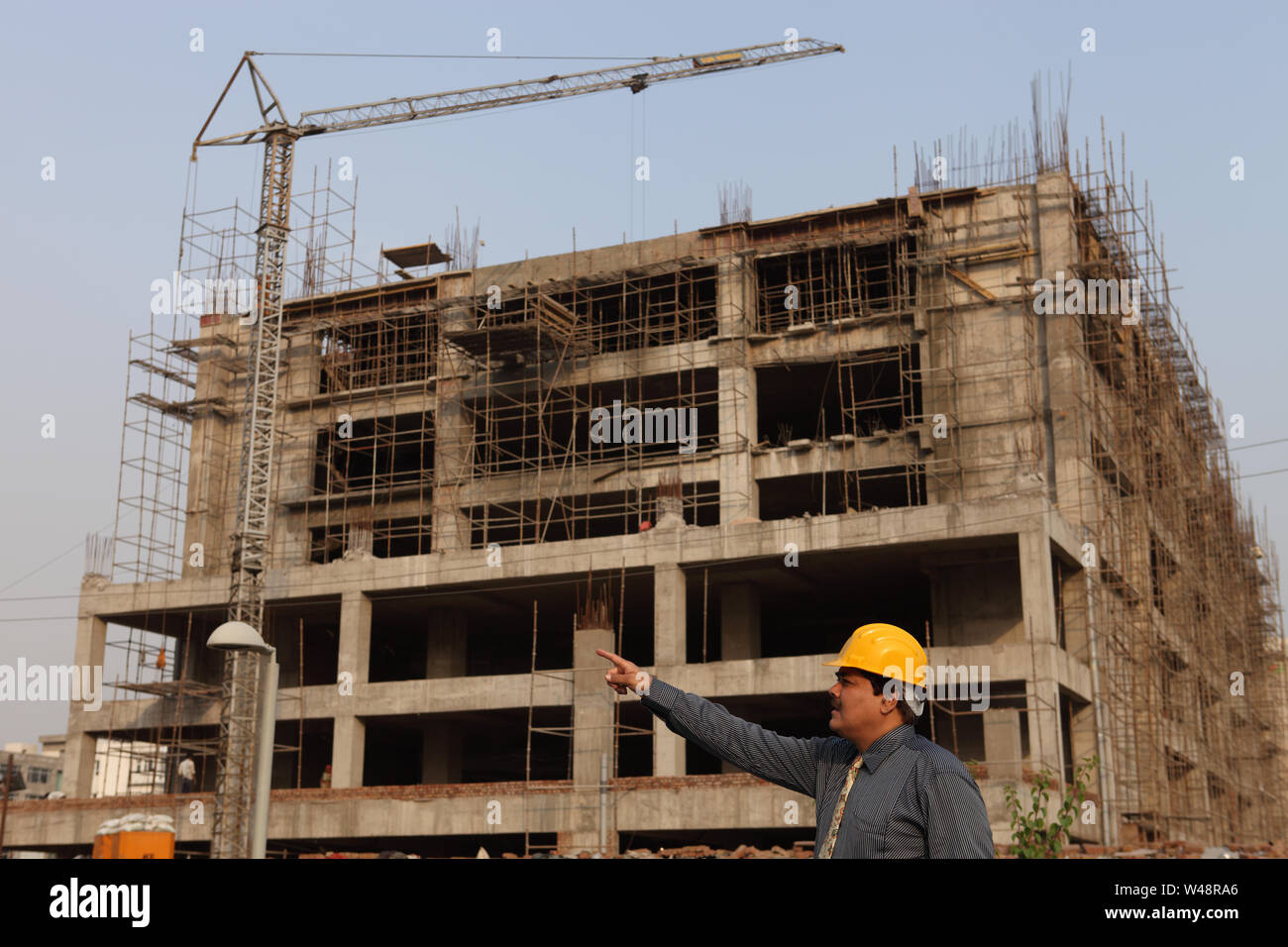 Architect pointing at construction site Stock Photo - Alamy