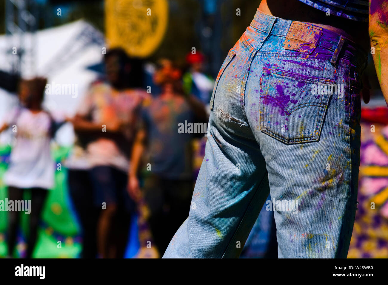 girl with colorful jeans, holi festival Stock Photo - Alamy