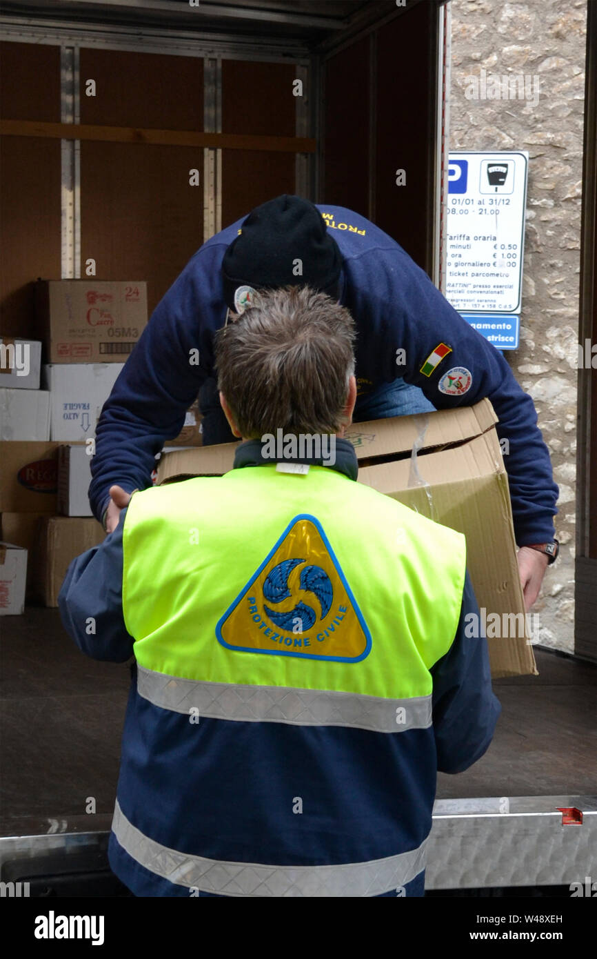 Rescue operations. Members of Protezione Civile, Civil Protection Department, working to provide food to people after flooding  - Italy Stock Photo