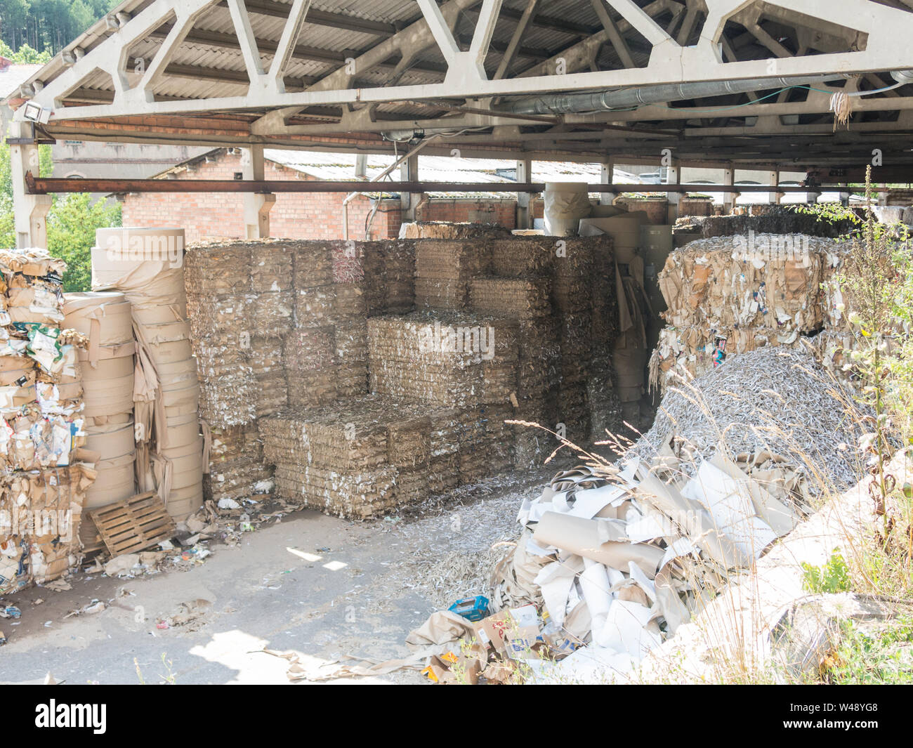 Recycled paper factory. Bales of cardboard, boxes and papers prepared to be recycled in a warehouse. Ecological industry. Catalonia, Spain. Stock Photo