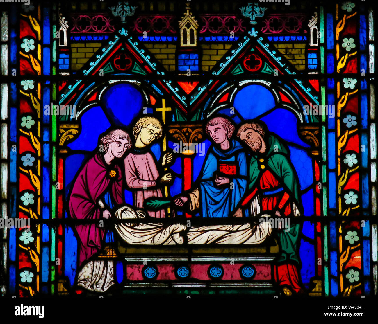 Stained Glass in the Cathedral of Notre Dame, Paris, France, depicting a Catholic burial rite Stock Photo
