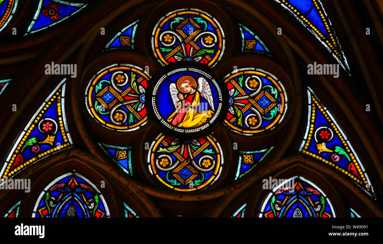 Stained Glass in the Cathedral of Notre Dame, Paris, France, depicting a praying Angel Stock Photo