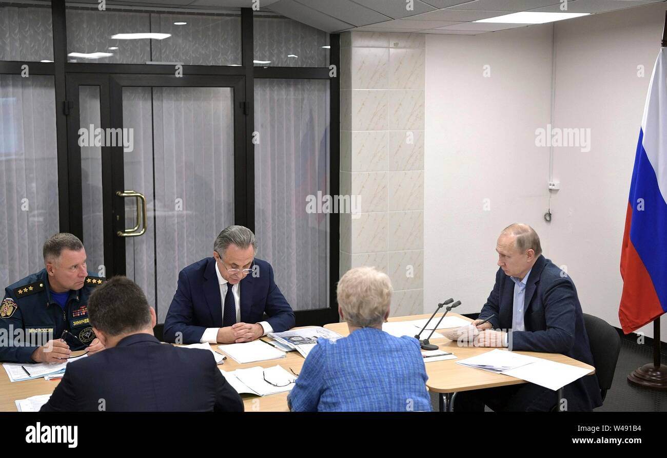 Russian President Vladimir Putin, right, meets with local and regional officials to discuss flood relief efforts in the Irkutsk Region July 19, 2019 in Bratsk, Irkutsk, Russia. The flooding in eastern Siberia is the worst in the recorded history of the region effecting 3,800 homes. Stock Photo