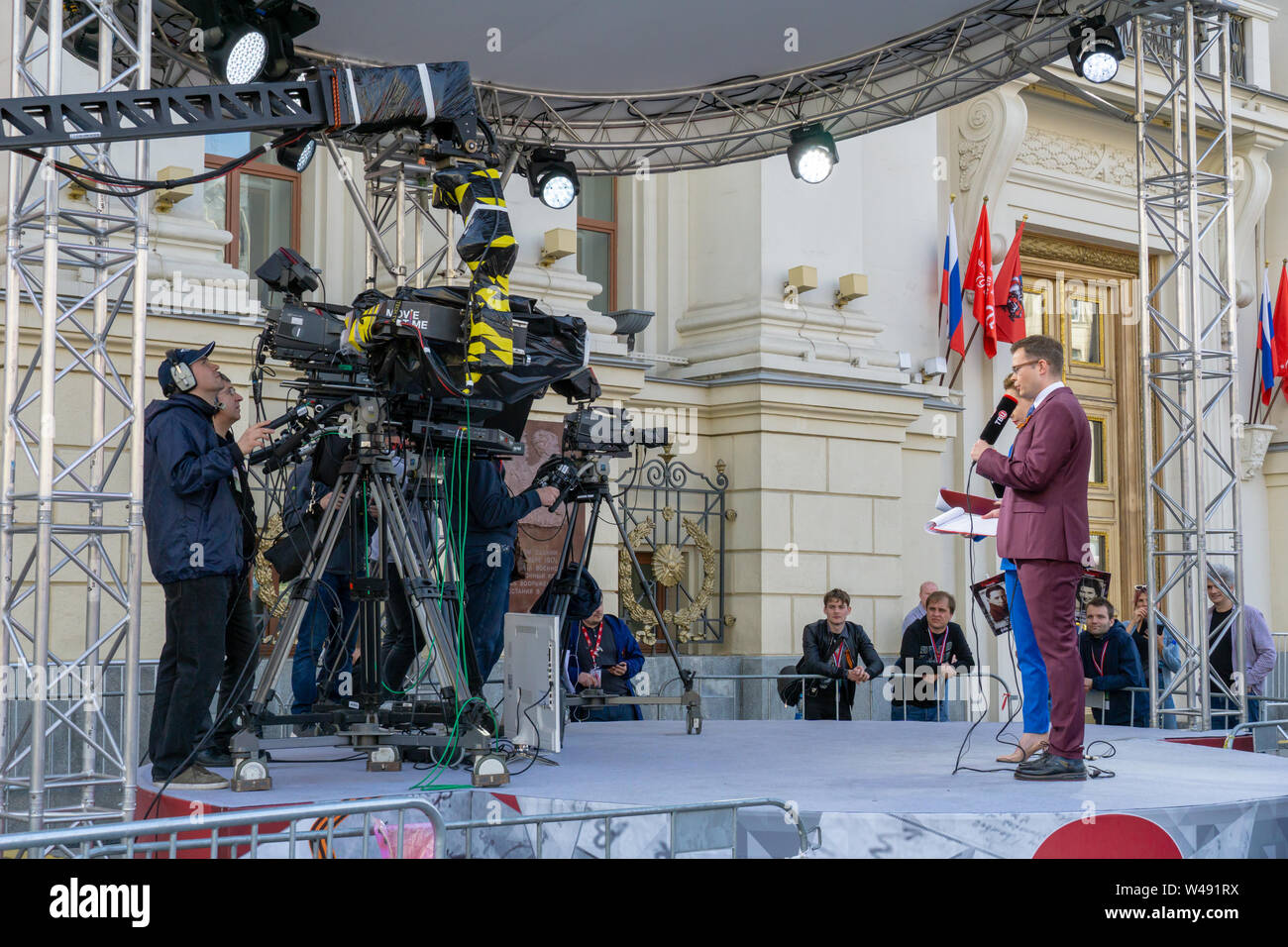 MOSCOW, RUSSIA - MAY 9, 2019: Recording TV program during the Victory Day Parade. TVC channel journalists are interviewing parade participants. Stock Photo