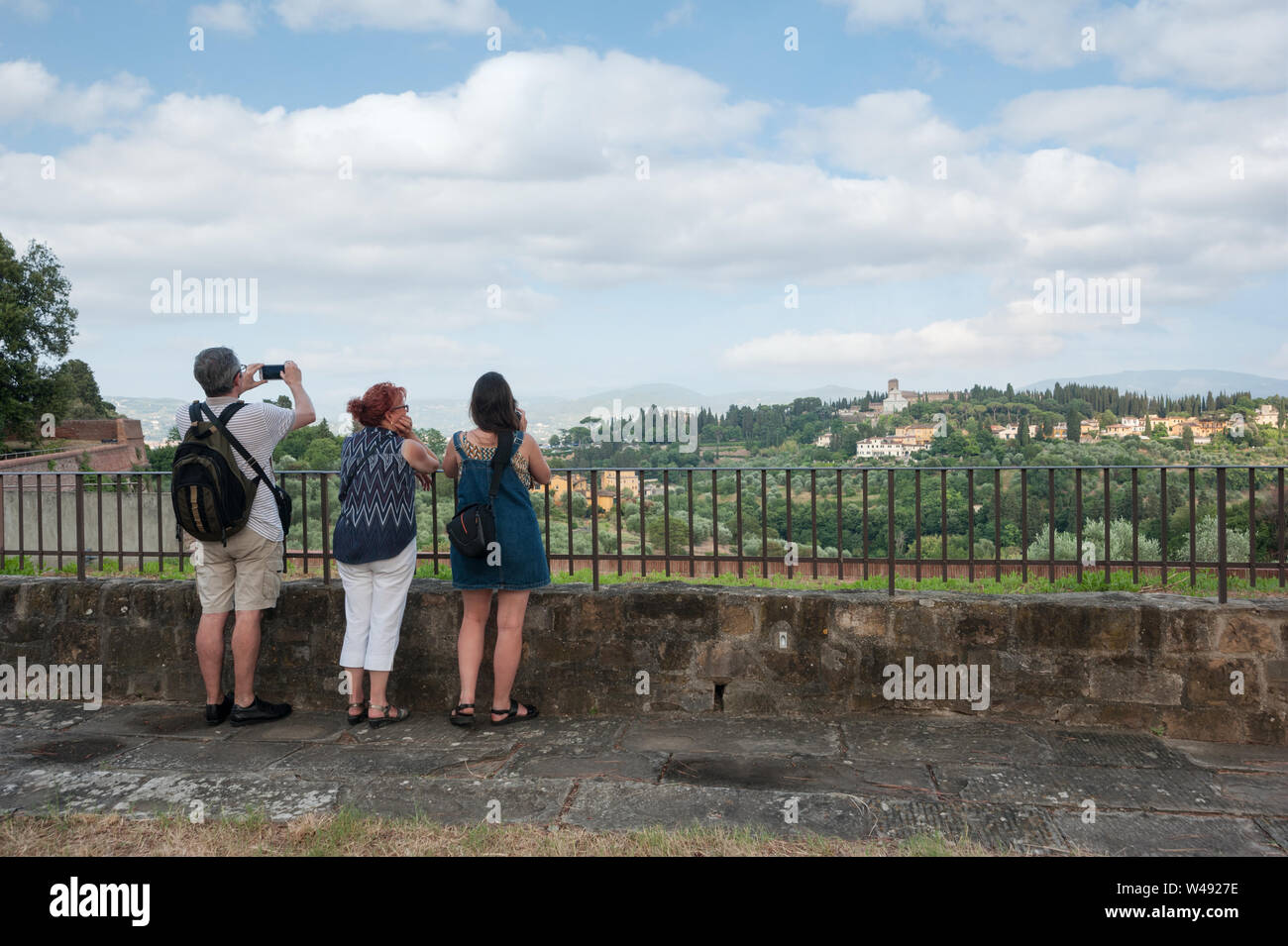 Florence, Italy - 2019, July 7: Tourists taking photographs and admire landscape from a terrace of the Fort Belvedere, in Florence. San Miniato al Mon Stock Photo