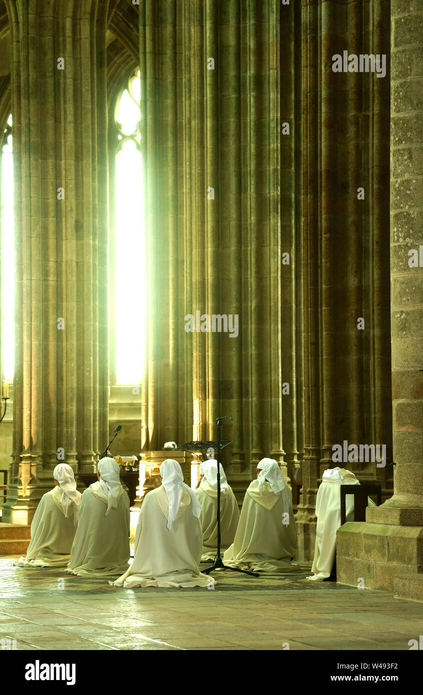 Nuns praying in church of Mount Saint Michel, Normandy, France Stock Photo