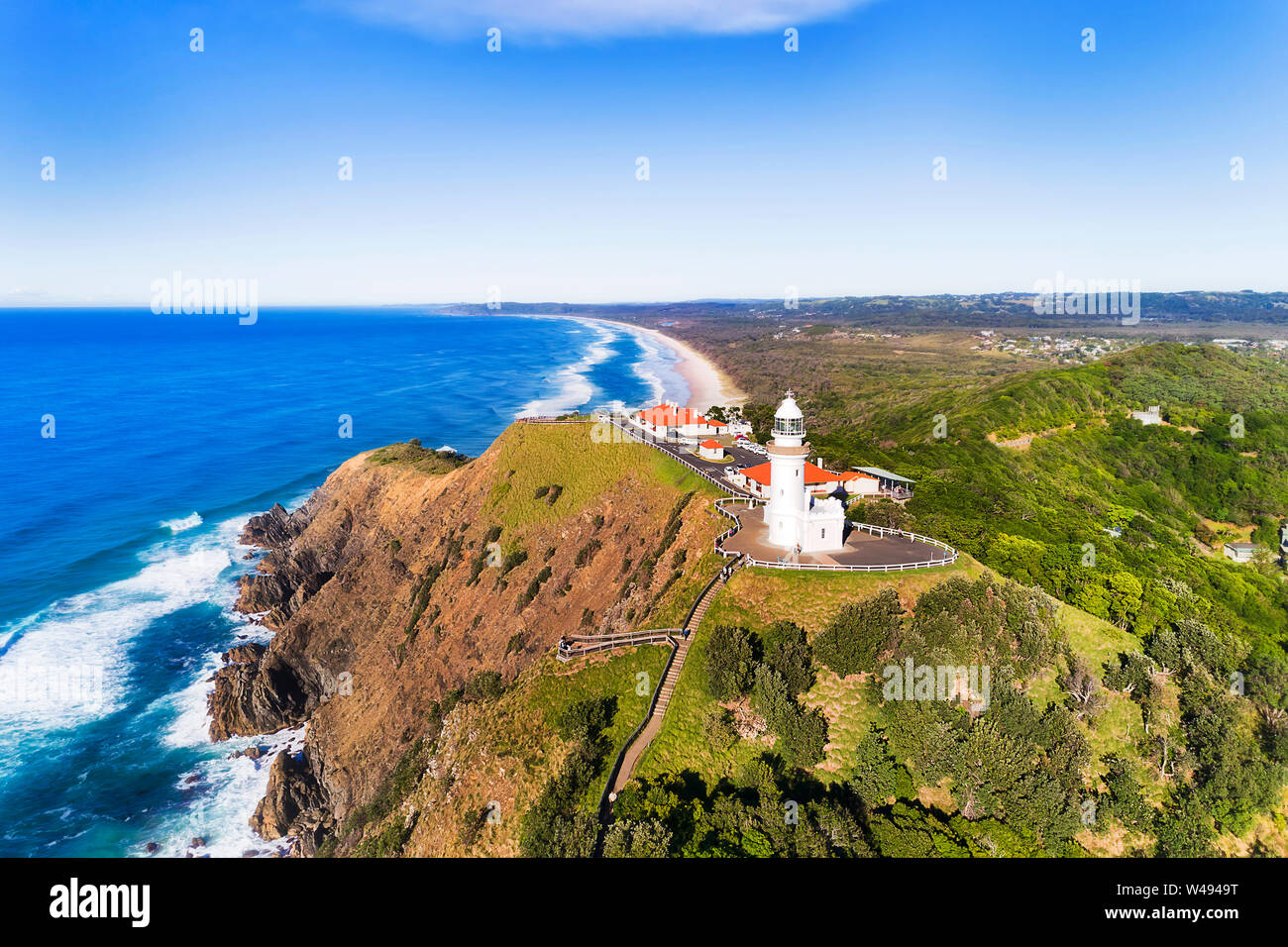 Famous Byron Bay white lighthouse on the top of Headlands on Australian pacific coast overlooking wide sandy beaches at the most eastern point of Aust Stock Photo