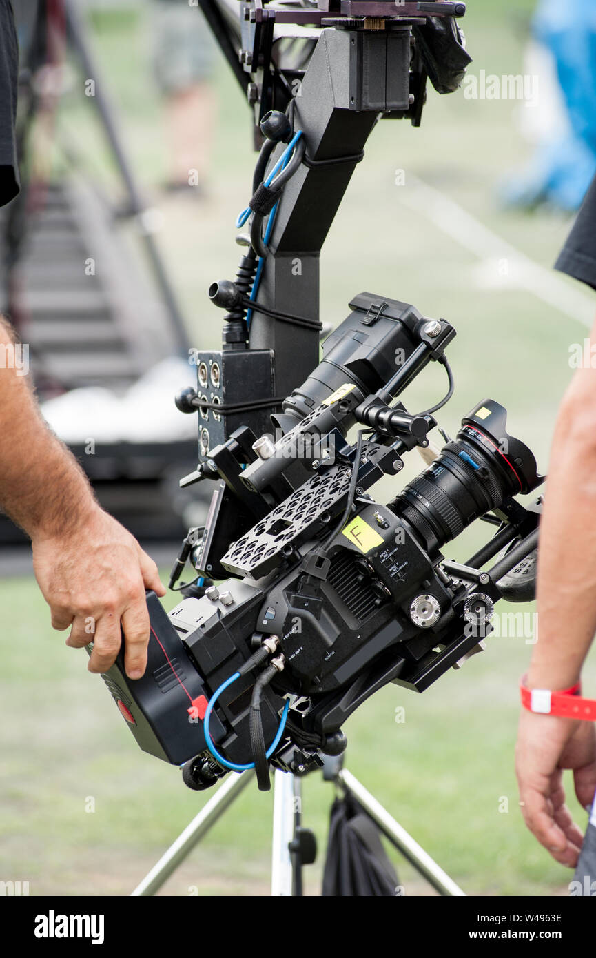 Technical camera operators set professional video camera on a large