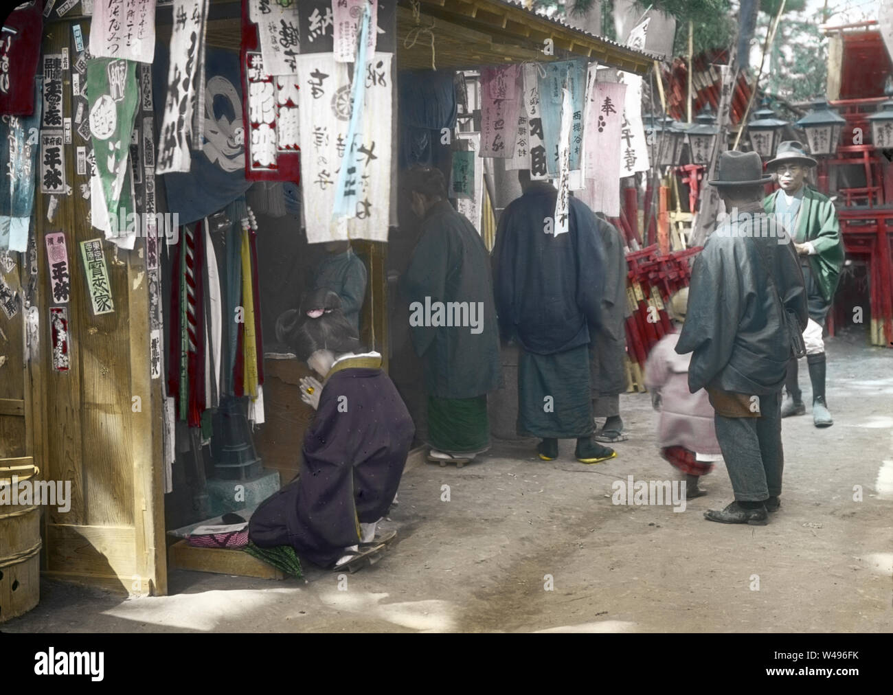 [ 1920s Japan - Japanese Woman Praying ] —   A woman in kimono is praying at the Anamori Inari Shrine (穴守稲荷神社) in Haneda, Tokyo. The shrine still exists and is popular with pregnant women and parents.  20th century vintage glass slide. Stock Photo