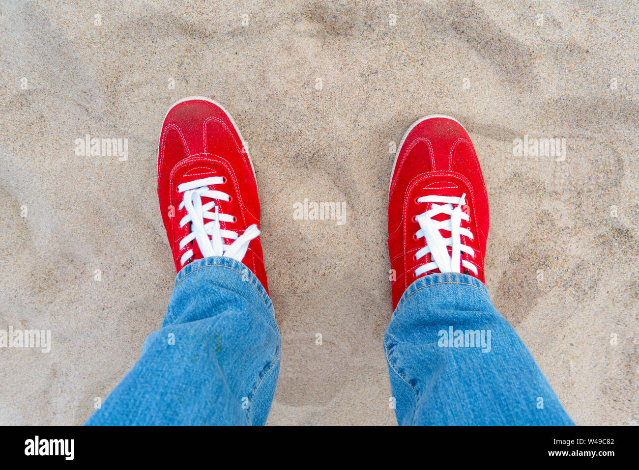 red sneakers and jeans