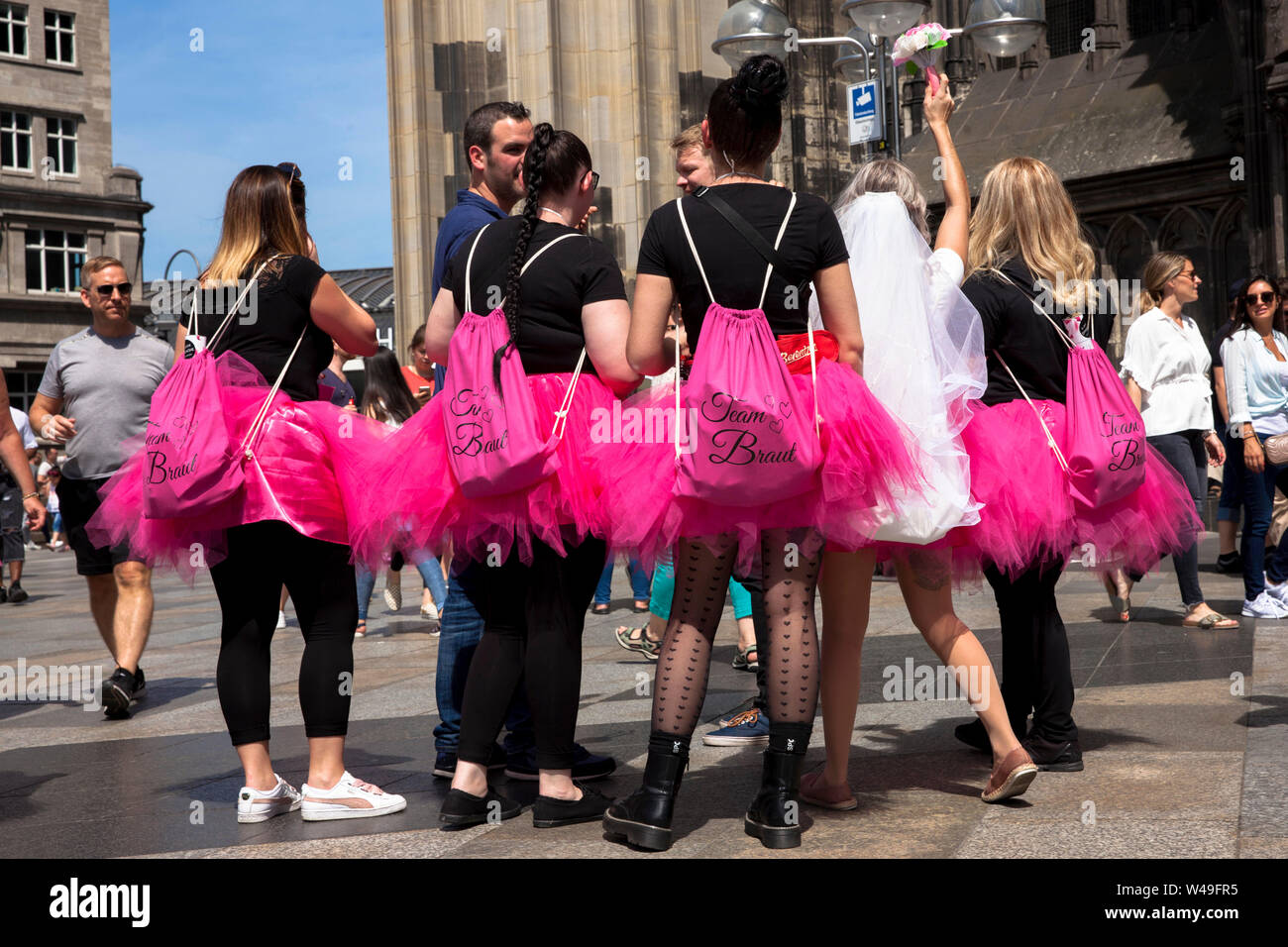bachelorette party, women in pink tulle skirts in front of the cathedral, Cologne, Germany.  Junggesellinnenabschied, Frauen in pinkfarbenen Tuellroec Stock Photo