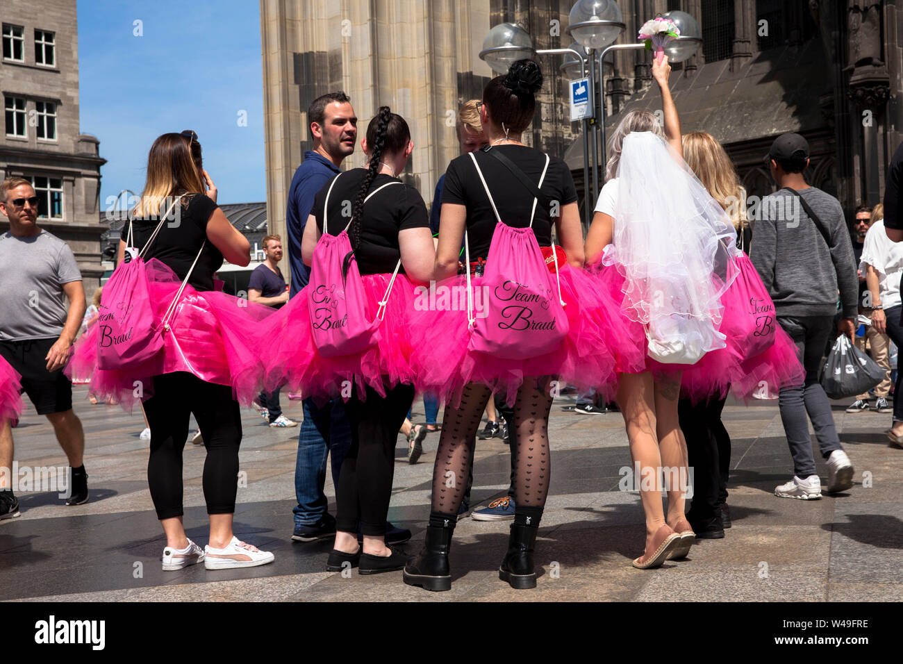 bachelorette party, women in pink tulle skirts in front of the cathedral, Cologne, Germany.  Junggesellinnenabschied, Frauen in pinkfarbenen Tuellroec Stock Photo