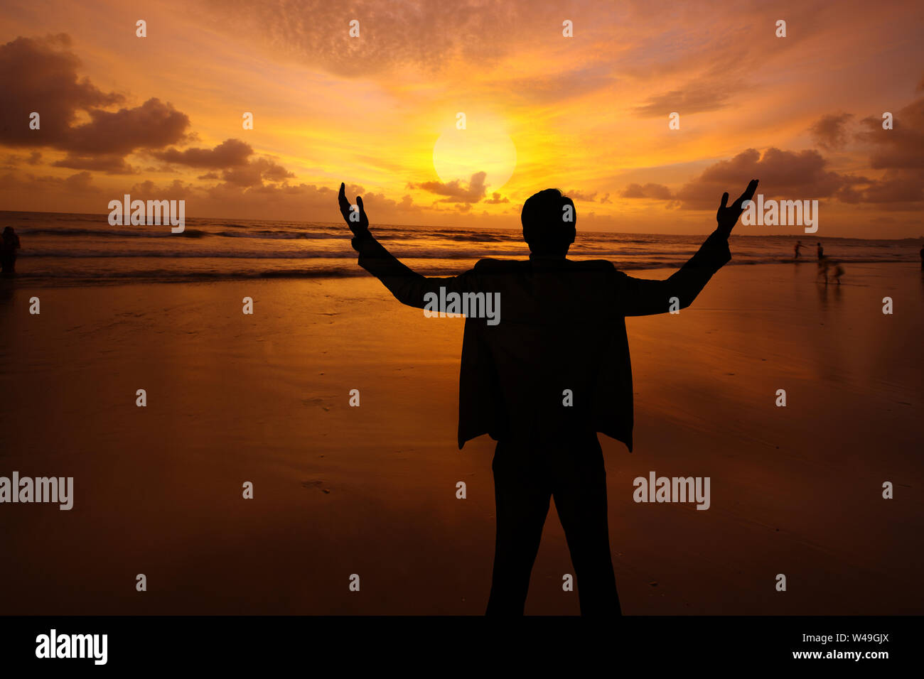 Silhouette of a businessman standing with his arms outstretched Stock ...